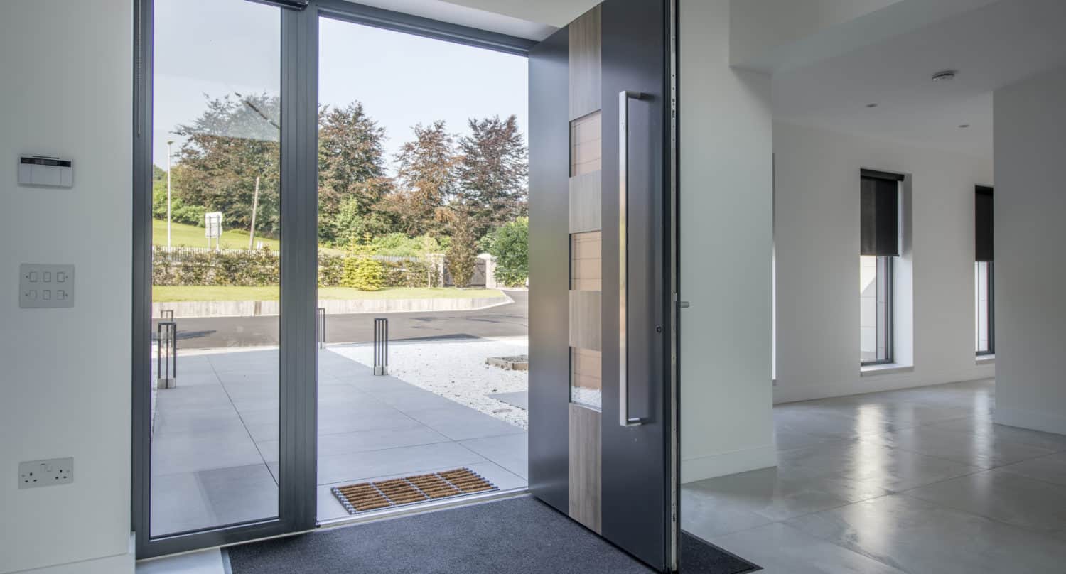Opened aluminium front door with a sidelight and 3 square glazed windows