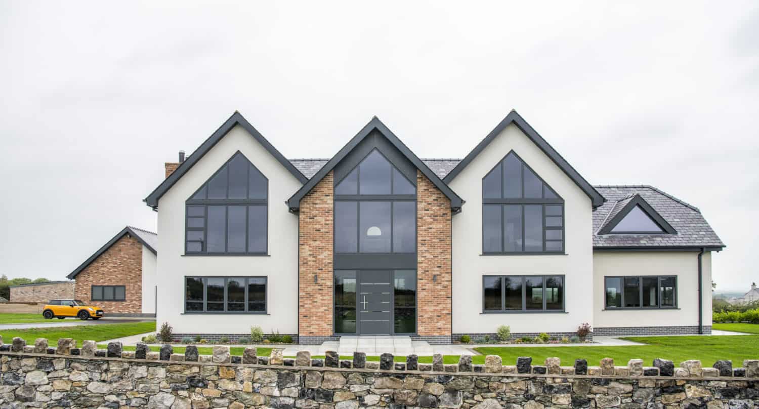 Luxury new build home featuring shaped aluminium windows and entrance door