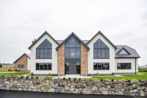 Luxury new build home featuring shaped aluminium windows and entrance door