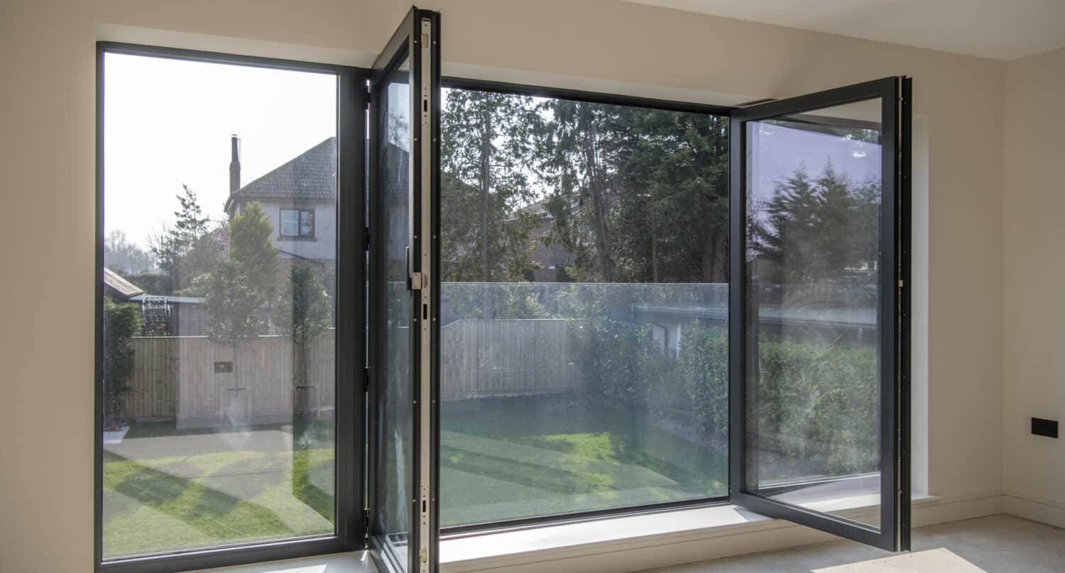 Open bespoke aluminum tilt and turn windows overlooking the garden
