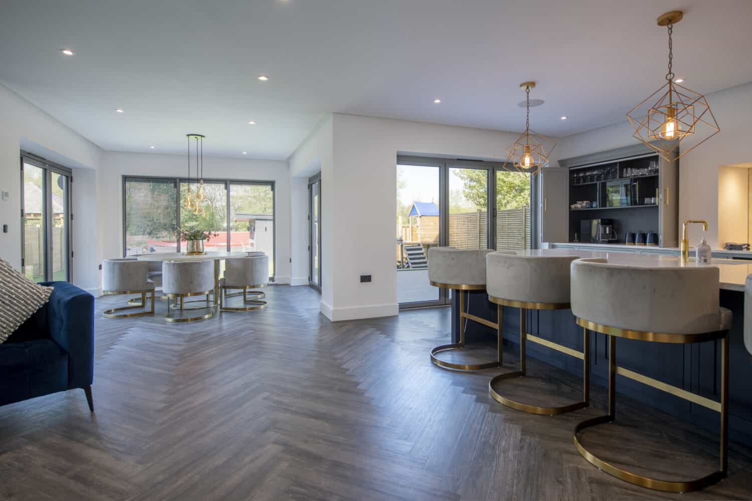 Modern open plan kitchen and dining area with custom bi-folding doors