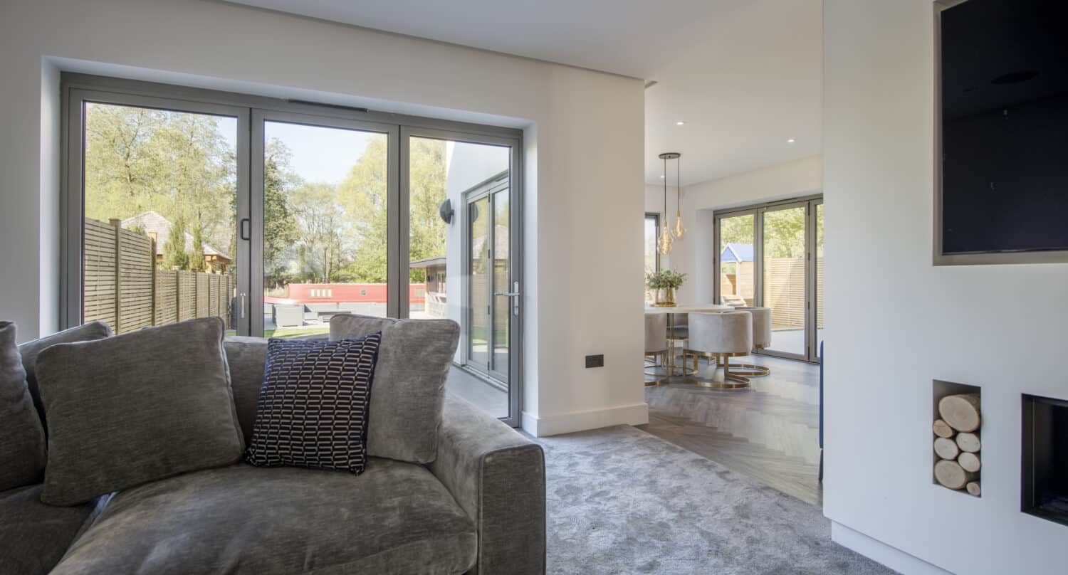 Bespoke aluminum grey doors illuminating a modern living room
