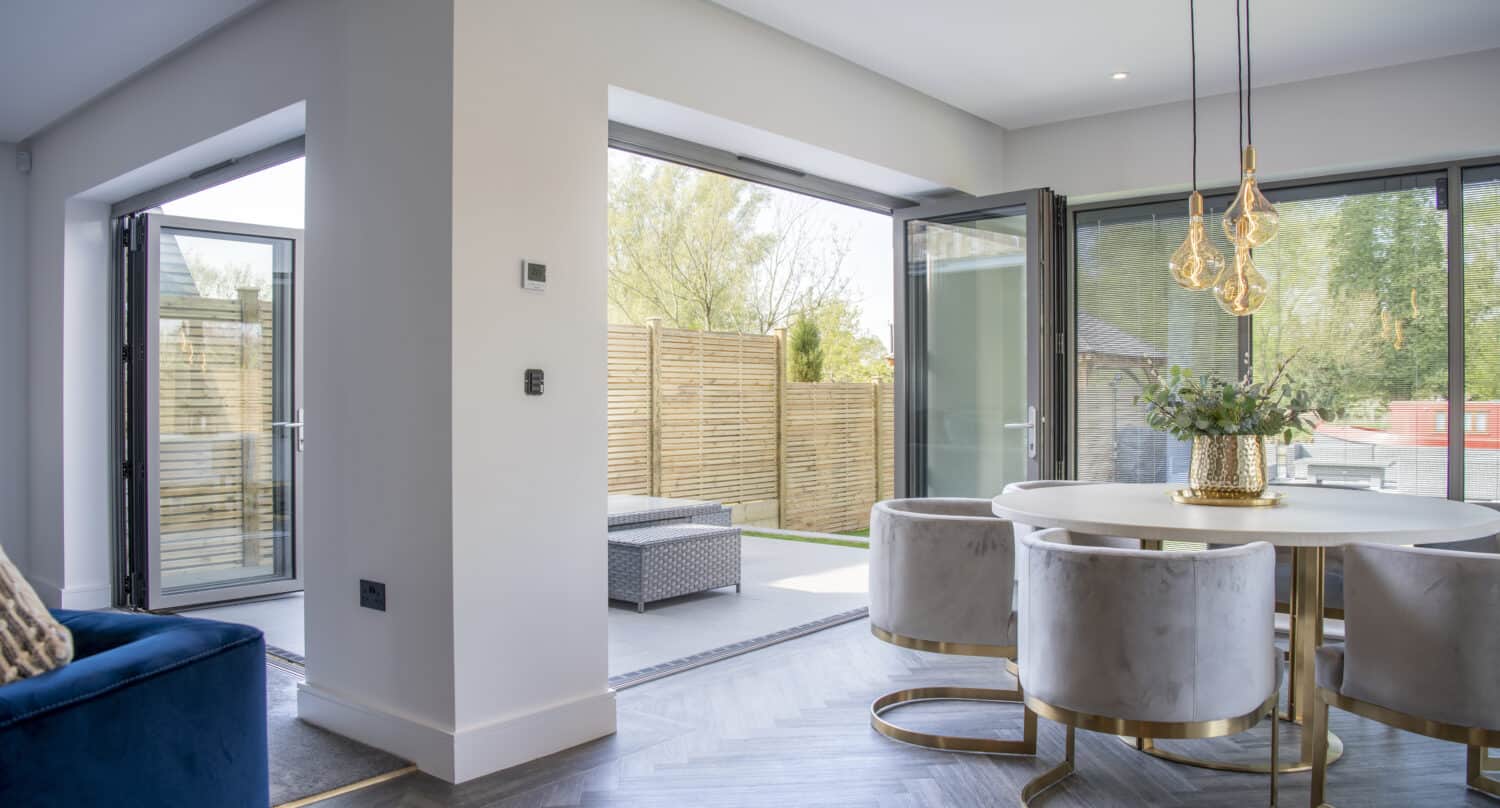 Open anthracite bifolding doors leading out to a spacious garden