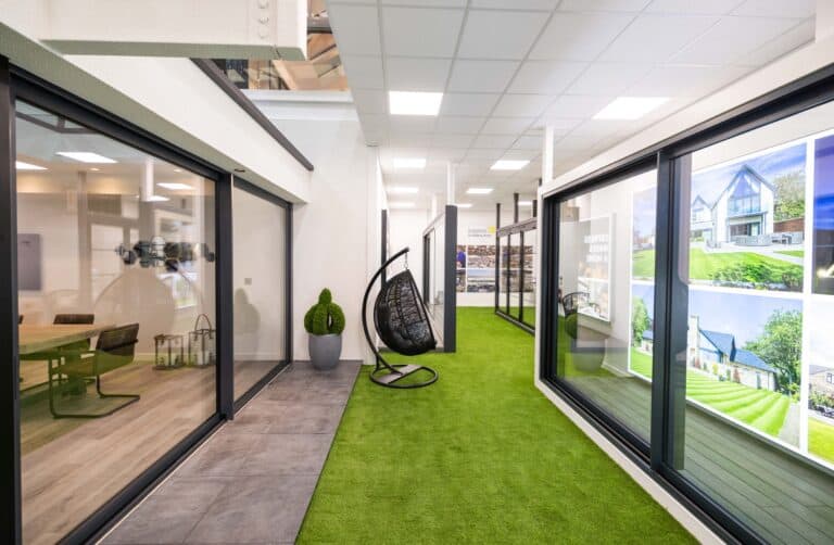 Sliding doors and a garden space with a hanging chair in a showroom