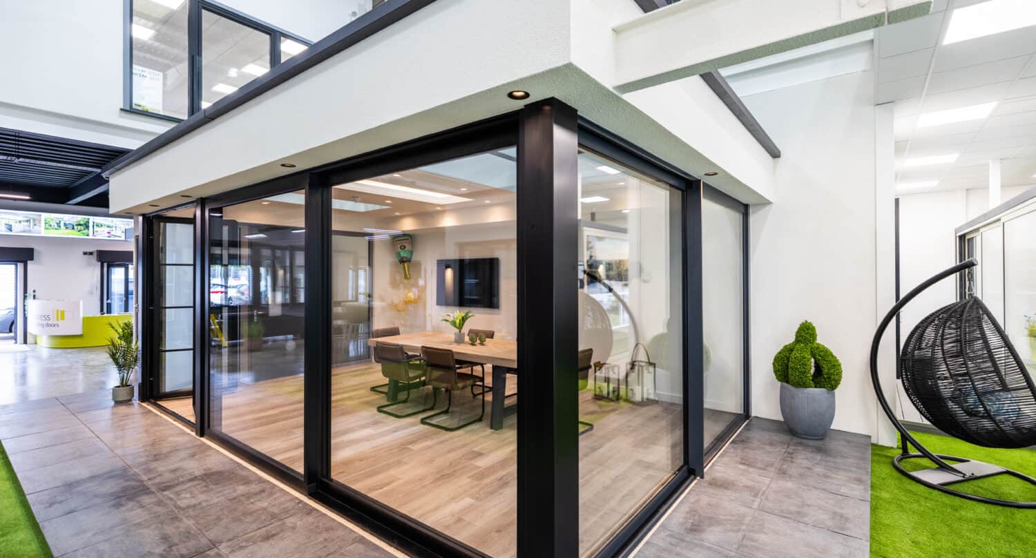 Dining rooms space featuring black sliding glass doors in a showroom