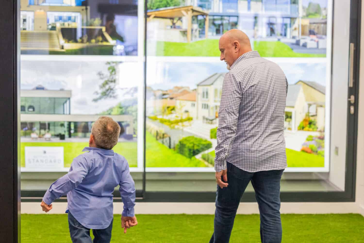Two men walking around a sliding door showroom