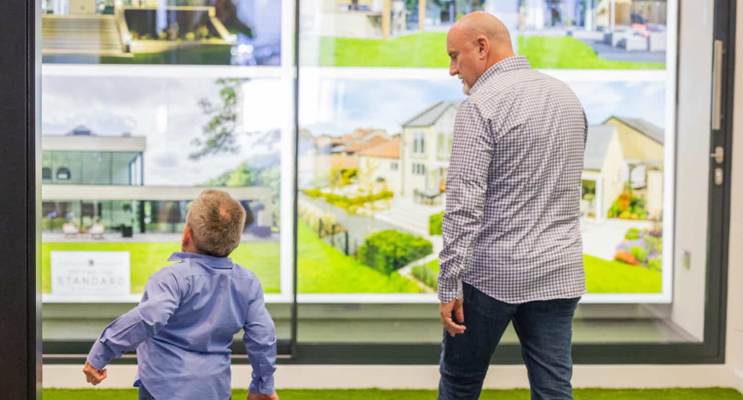 Two men walking around a sliding door showroom