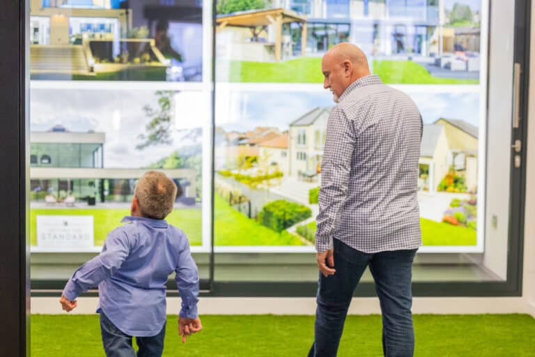 Two men walking around a sliding door showroom