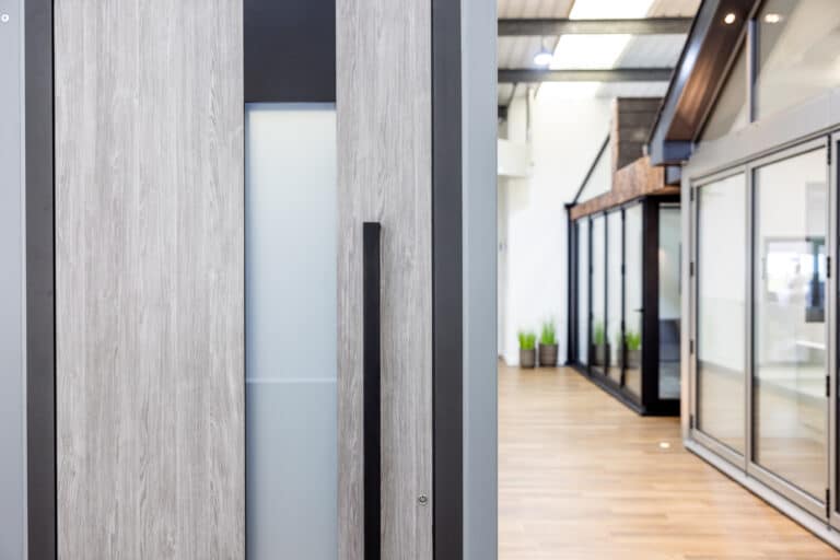 Premium natural oak finish entrance door with long black handle and glazed window