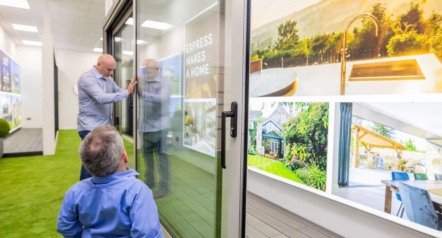 A man opening a sliding door in a showroom