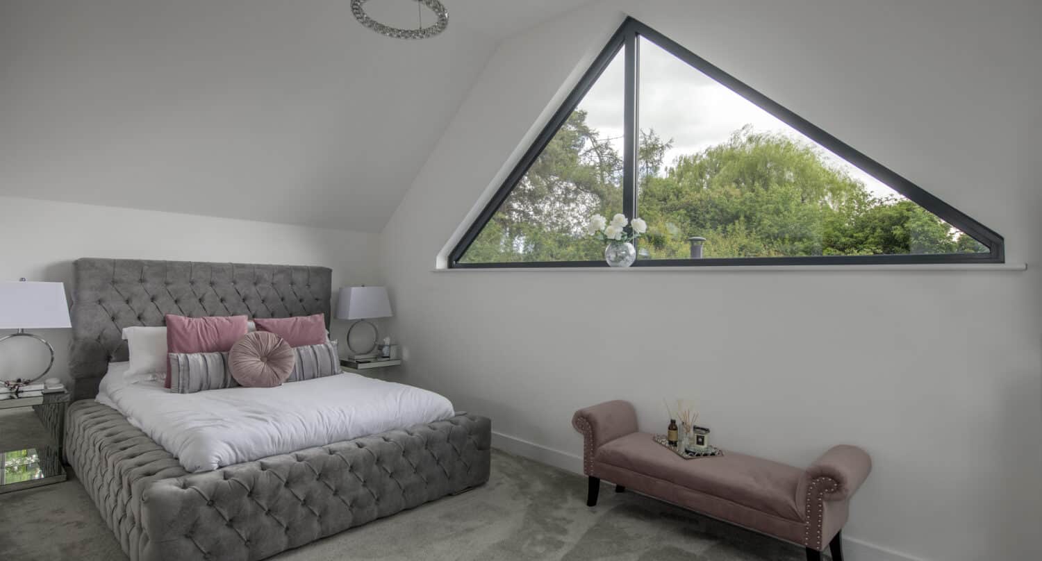 Modern bedroom featuring an aluminium triangle shaped window