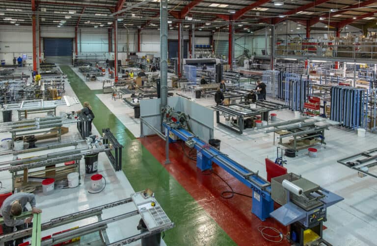 Technicians working in a bifold doors and aluminium windows manufacturing warehouse