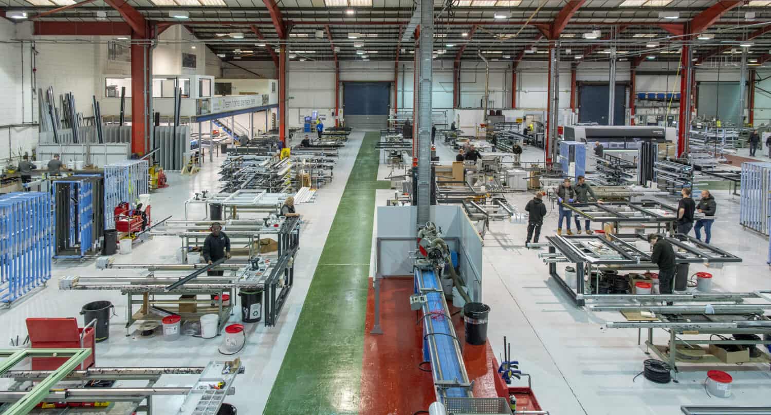 Window technicians working in a manufacturing warehouse
