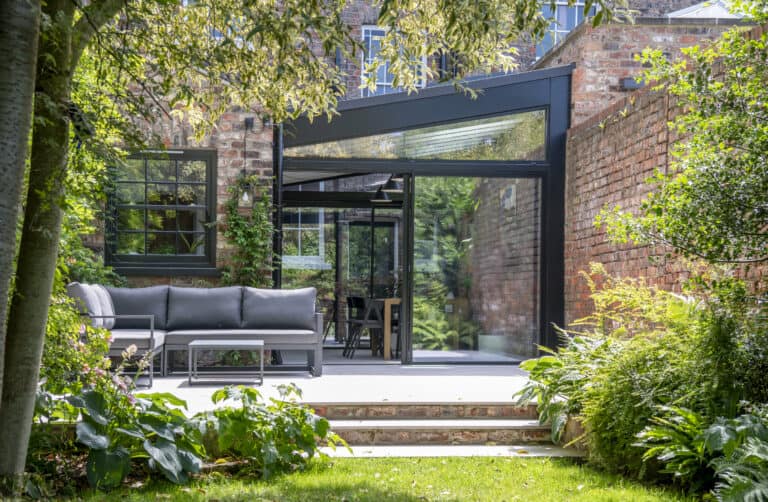 Impressive Victorian terrace house extension featuring black sliding doors