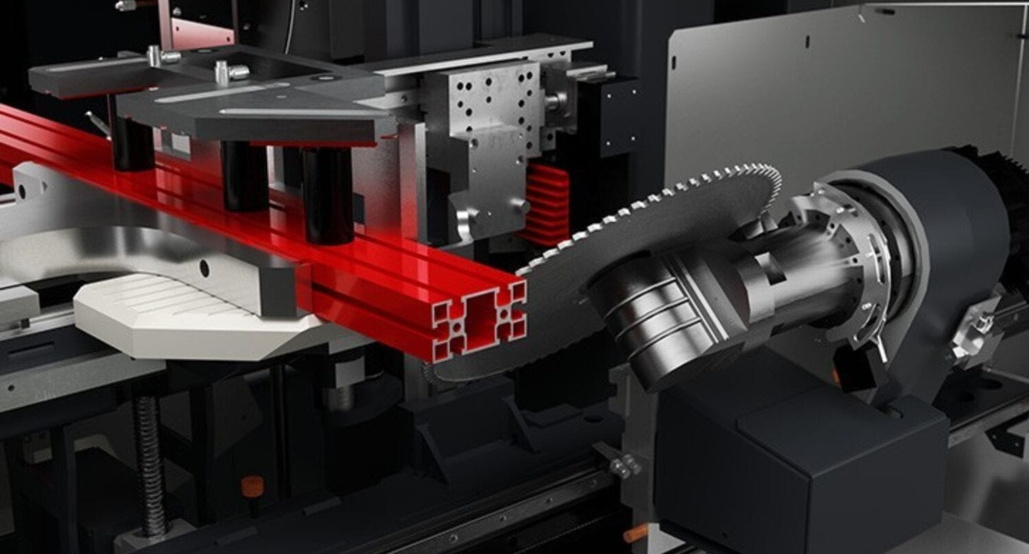 Close-up view of an industrial CNC machine processing a metal profile; red laser beams indicate alignment within the high-precision automated equipment, ideal for creating bespoke glass solutions or components for bifold doors.