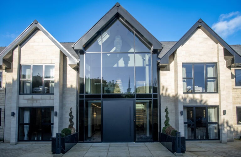Elegant bi-folding doors with large glass panels, perfect for connecting indoor and outdoor living spaces in contemporary homes.