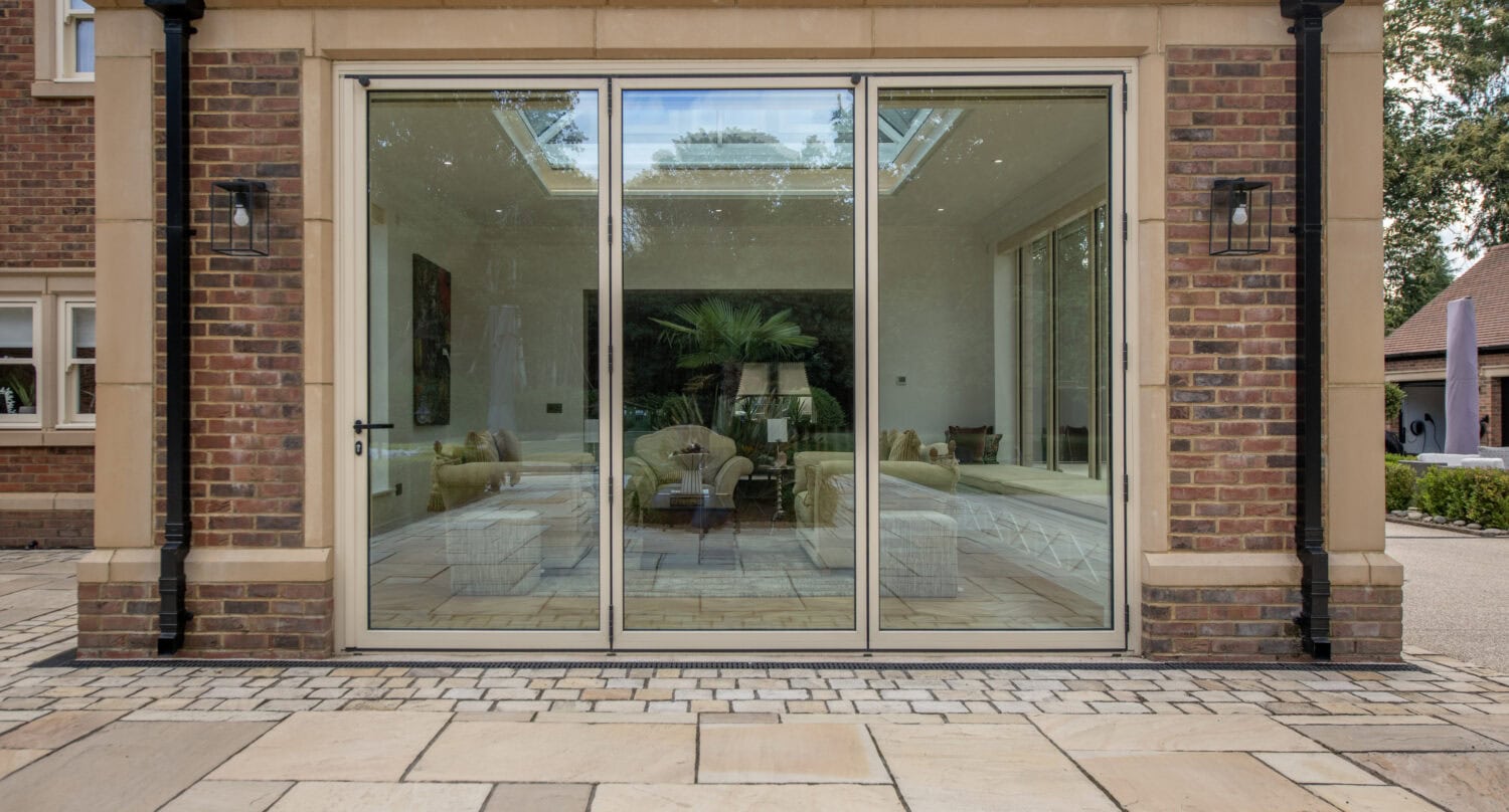 Modern glass bi-folding doors installed at Foxwood House, providing seamless indoor-outdoor living space and natural light.